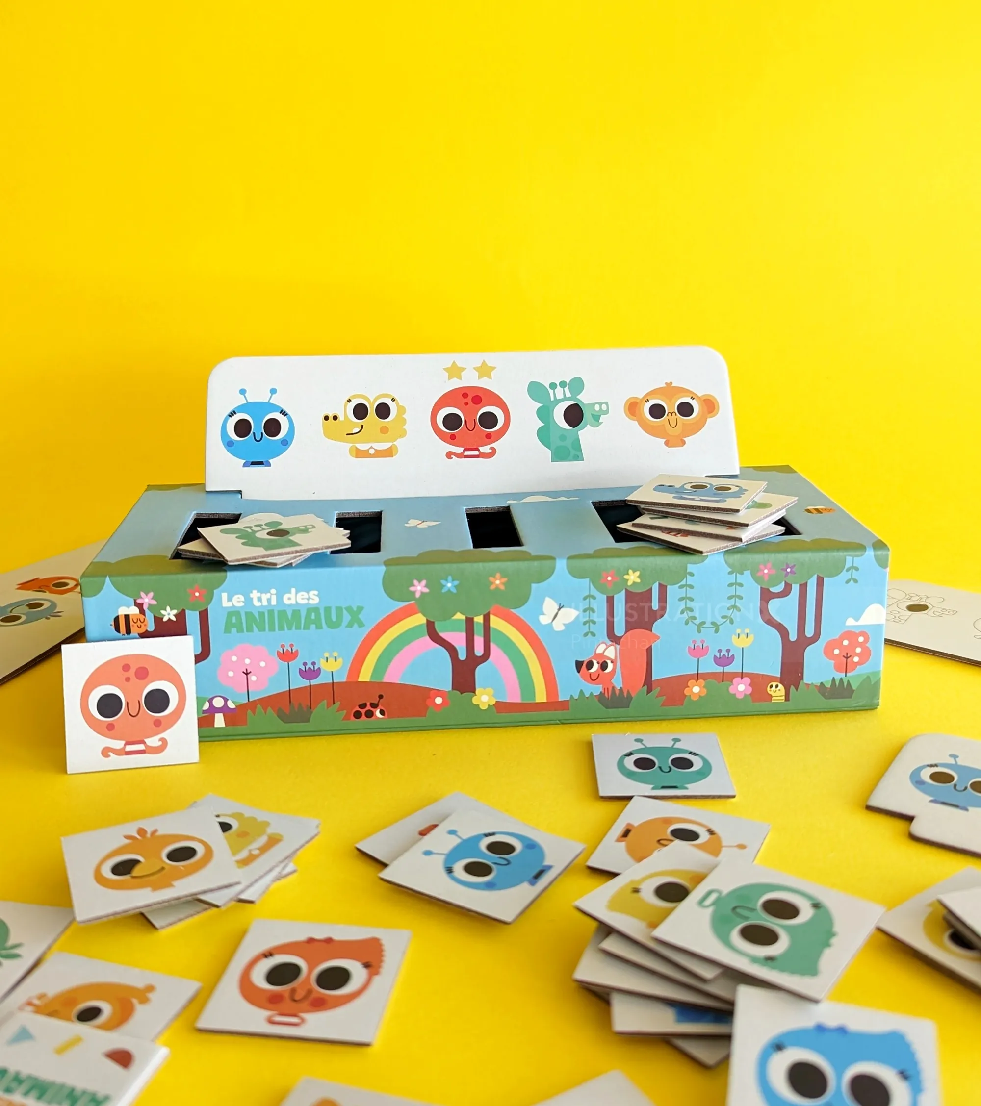 Educational animal face matching game with cards and colorful box