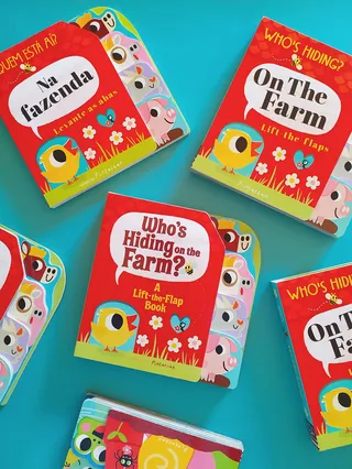 Children's colorful farm-themed lift-the-flap books in English and Portuguese