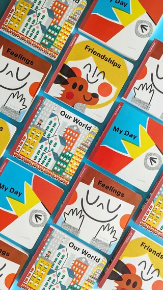 Illustrated cards with themes of feelings, friendships, and daily routines on red background.