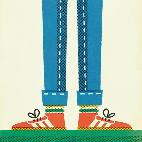 Legs in blue jeans and red sneakers with white laces