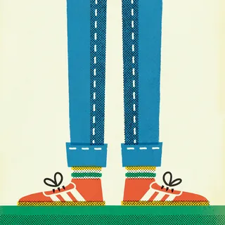 Legs in blue jeans and red sneakers with white laces