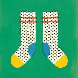 Pair of white socks with black dots, yellow toes, and red stripes