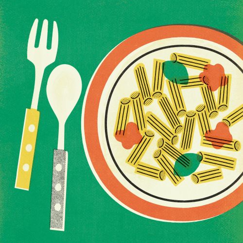 Plate of pasta with sauce and fork and spoon on green background