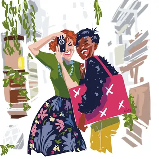 Two friends smiling as one takes a photo using a camera by Quincy Sutton