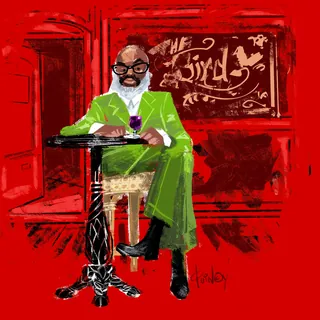 Man in green suit sitting at table with wine glass by Quincy Sutton