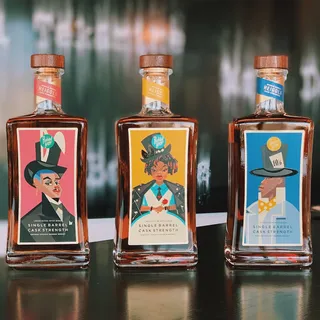 Alice in Wonderland-themed labels for Rabbit Hole Whiskey