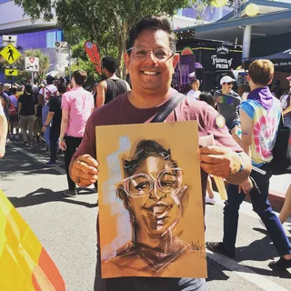 Live event drawing man smiling with his art
