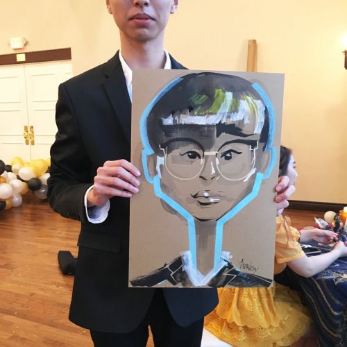 Live event drawing of a boy with glasses
