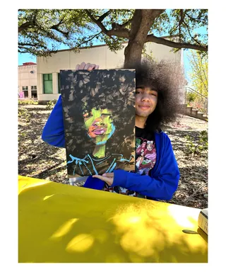 Person holding an Afro portrait in ink and acrylic by Quincy Sutton