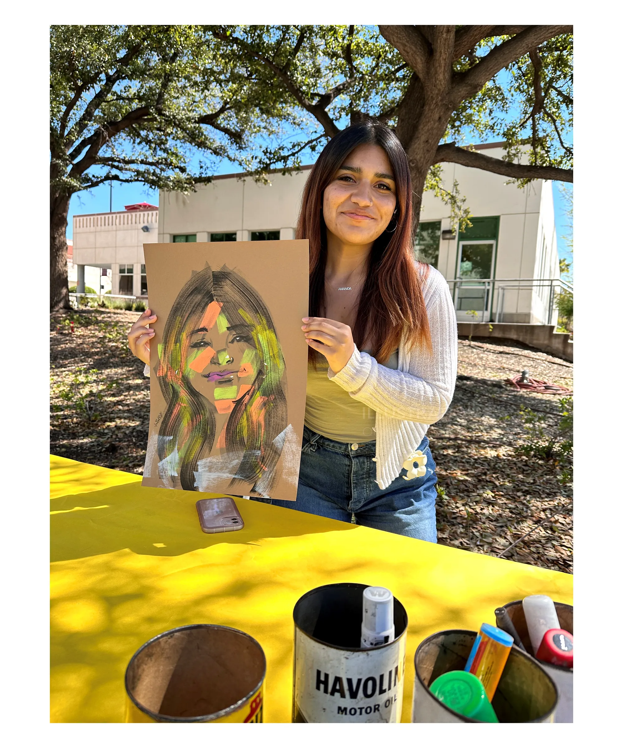 Woman holding a vibrant portrait drawing outdoors by Quincy Sutton