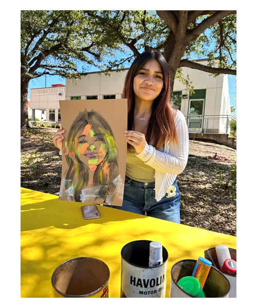 Woman holding a vibrant portrait drawing outdoors by Quincy Sutton