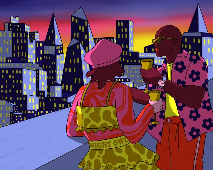 Couple enjoying drinks on a city rooftop at sunset by Rachel Winter