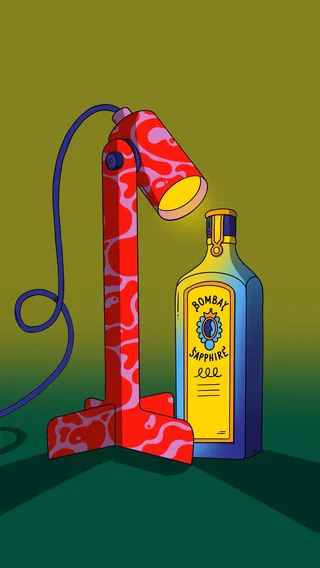 Red patterned lamp shining light on a Bombay Sapphire bottle