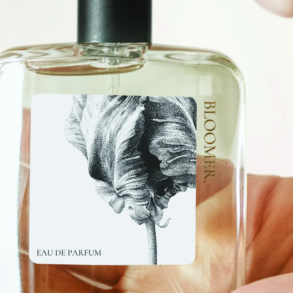 Glass perfume bottle with Bloom Eau de Parfum label and botanical illustration by Reiko Lauper