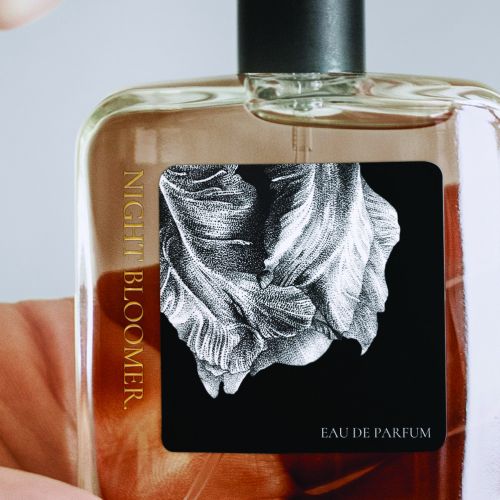 Eau de parfum bottle with a flower label, photographed by Reiko Kato