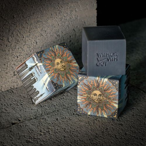 Reiko Kato artwork showing a sunburst illustrated book beside a matching gray box.