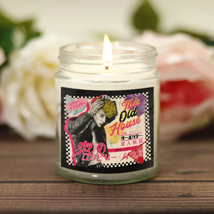 Lit vintage scented candle with comic-style label by Reiko Lauper
