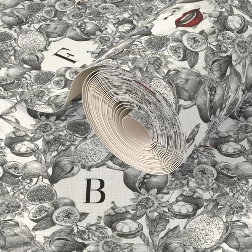 Rolled wallpaper featuring black and white fruit and floral patterns and letters