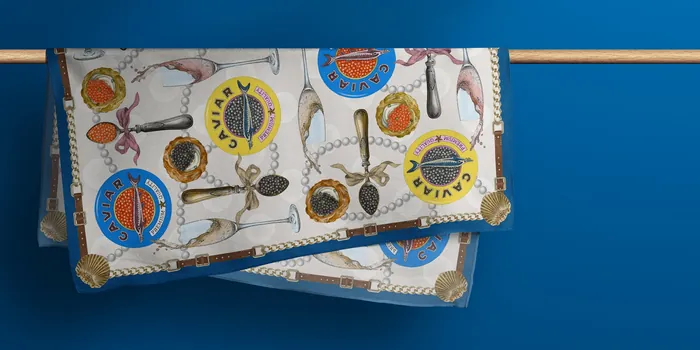 Silk scarf featuring compasses and nautical-themed illustrations