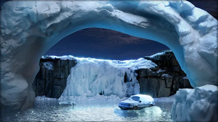 Car covered in snow near icy cave formation with frozen water by RIVE GAUCHE
