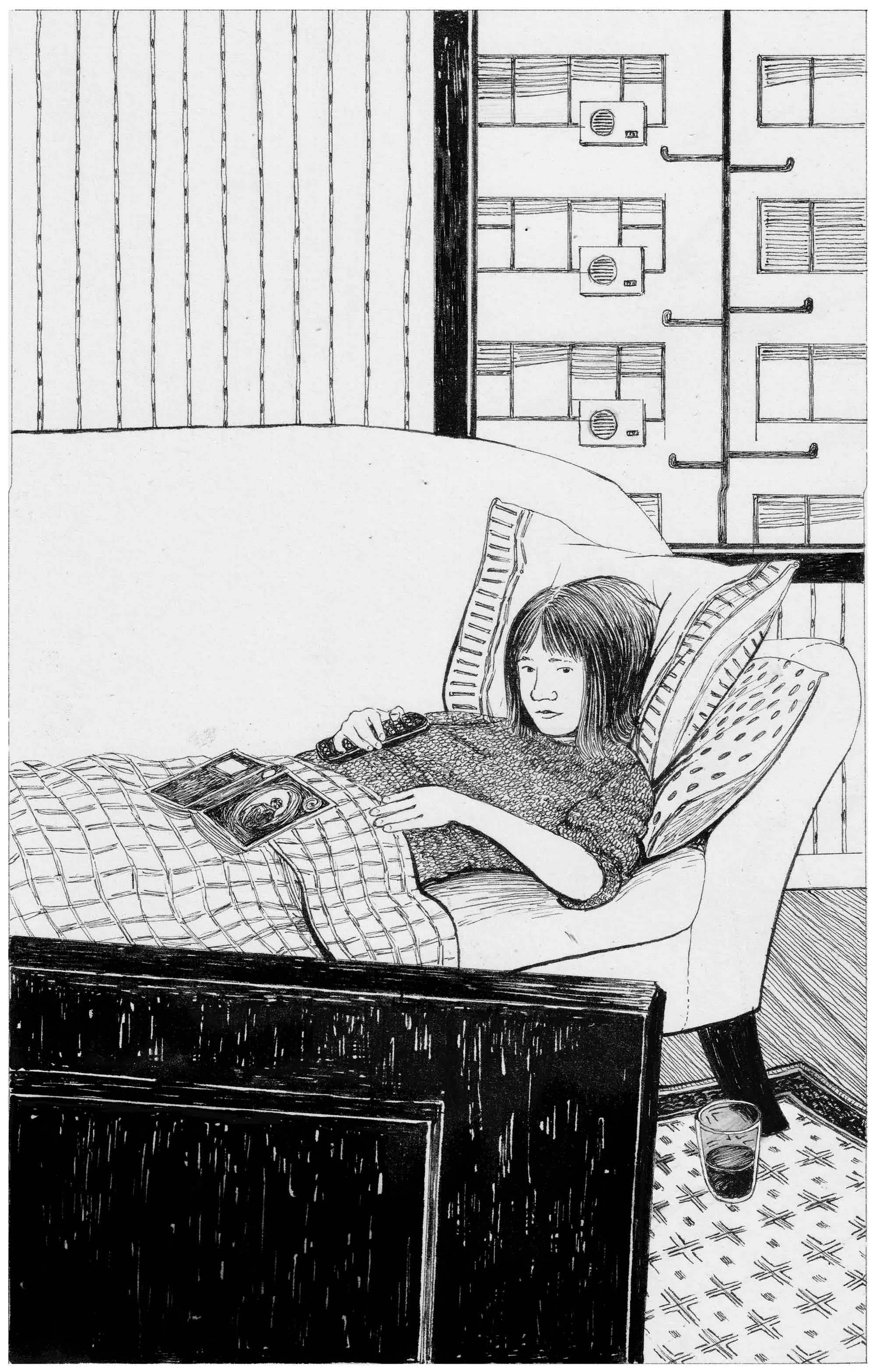 Girl lying on couch reading book indoors by Rohan Eason