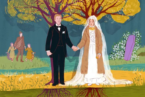 Bride and groom standing hand in hand outdoors with colorful trees.
