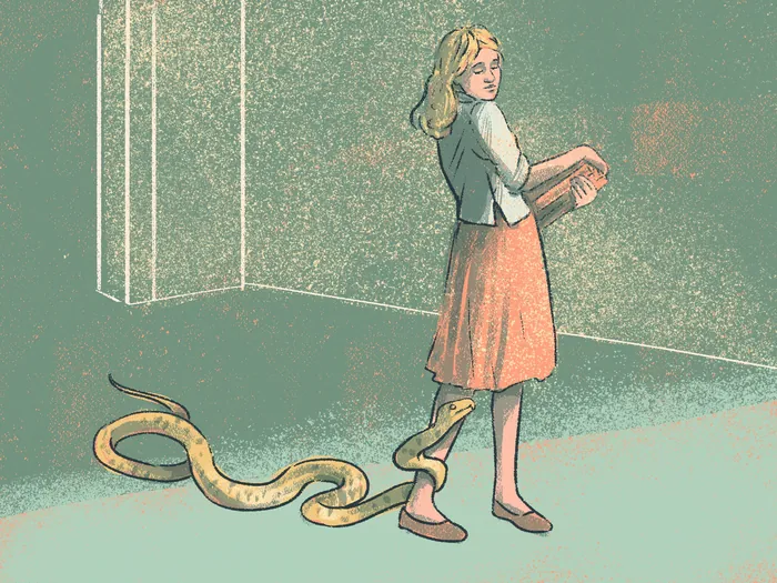 Woman standing near a snake in a room