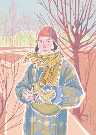 Person wearing winter coat, scarf, and gloves standing outside near leafless trees.