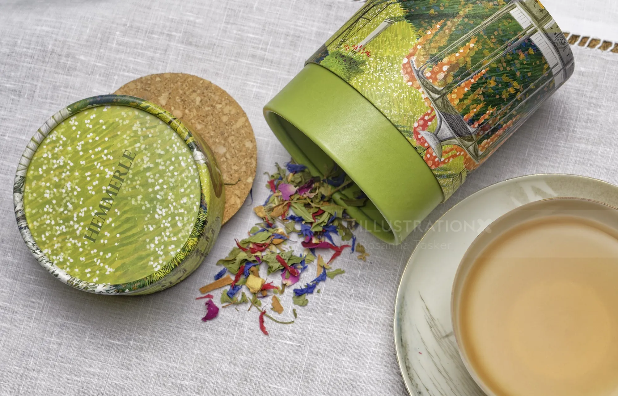 Herbal tea leaves spilling from green tin with brewed tea cup by Rosanna Tasker