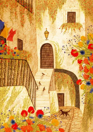 Mediterranean alley with stairs, colorful flowers, and a cat walking.