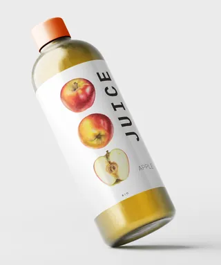 Bottle of apple juice with label showing apples and text