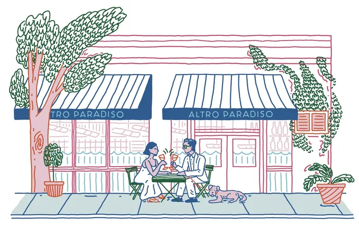 Couple dining outdoors at Altro Paradiso restaurant with a dog nearby