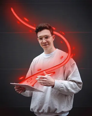 Person drawing glowing red light swirl above tablet by Samy Löwe