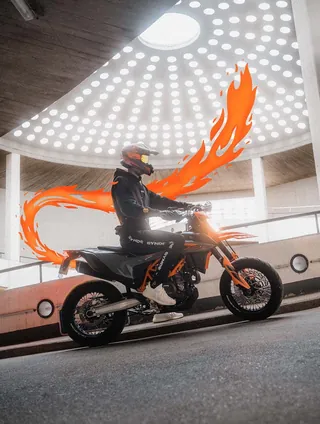 Motorcyclist on a bike with fiery orange trail in modern circular building by Samy Löwe