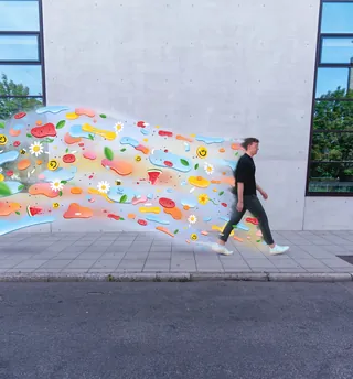 Man walking with colorful abstract shapes trailing behind