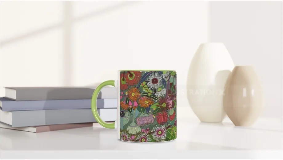 Colorful floral patterned coffee mug on white table with stacked books and decorative vases by Sarah