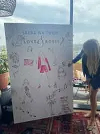 Person creating large live fashion illustration at event