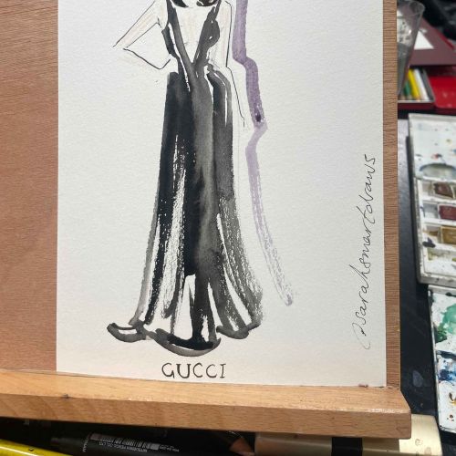 Watercolor fashion illustration of woman in long black Gucci dress