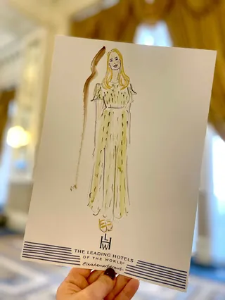 Fashion illustration of woman in flowing dress at hotel event
