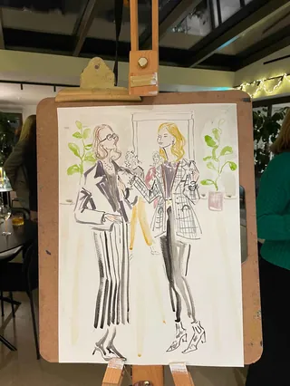 Fashion illustration of two women in striped outfits on clipboard