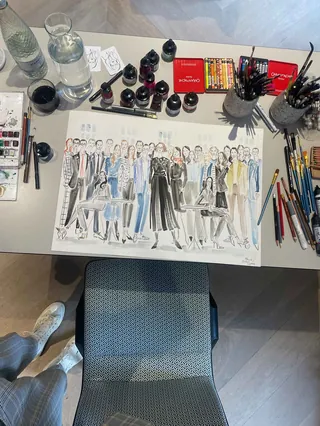 Live painting of diverse group at LVMH event on artist desk