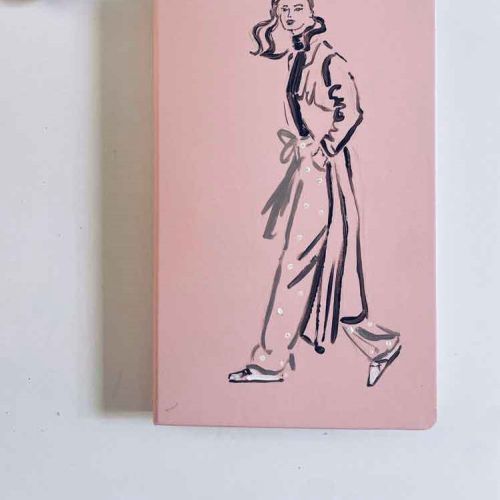 Illustration of a woman walking on a pink notebook cover