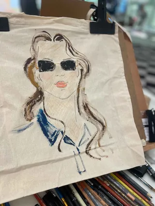 Canvas tote bag with live painting of woman wearing sunglasses