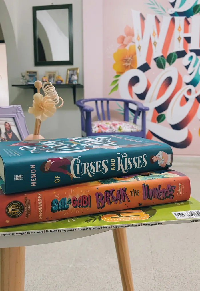 Stacked books on table in cozy room by Saskia Bueno