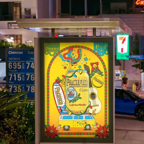 Colorful arcade game poster beside a gas station, photographed by Season of Victory.
