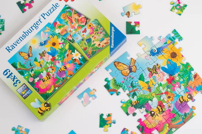 Partially completed Ravensburger puzzle with butterflies and flowers