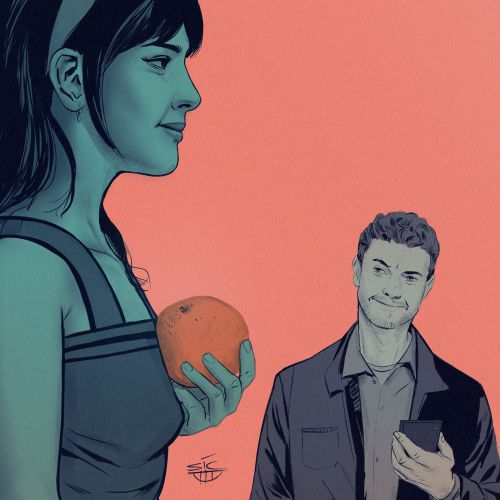 Woman holding an orange with a man smiling nearby