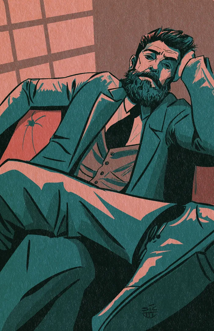 Bearded man reclining on couch in a relaxed pose