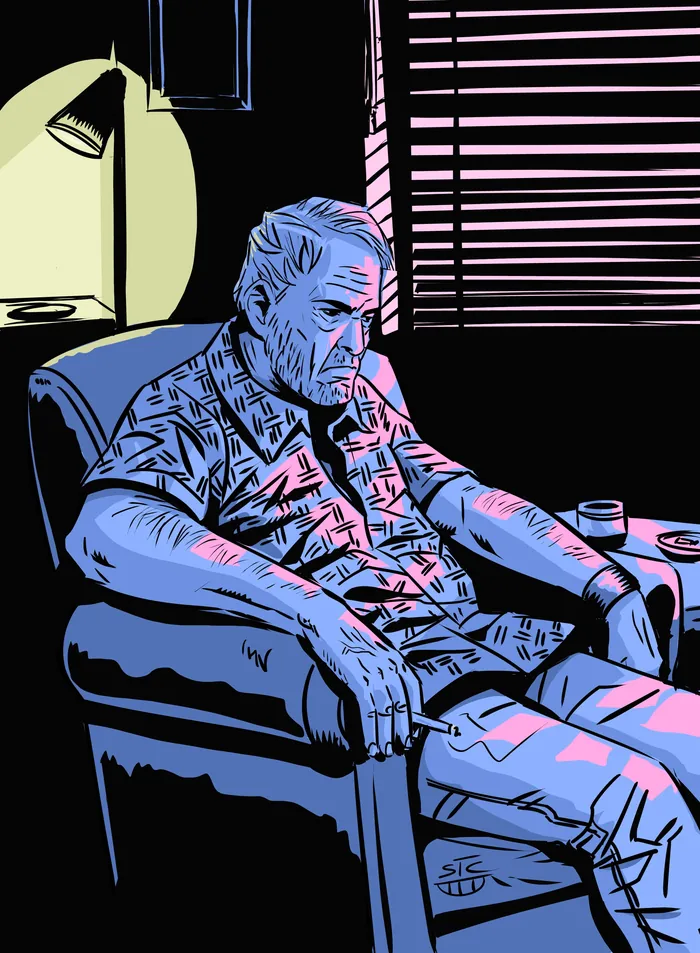Man sitting in an armchair, looking contemplative in moody lighting