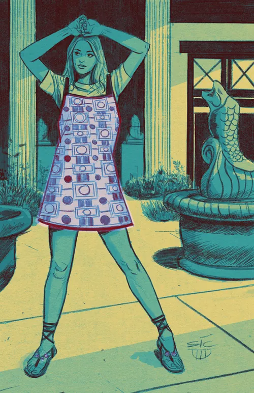 Woman wearing patterned smock in outdoor courtyard with fountain